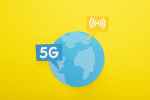 top view of globe and 5g lettering on yellow background